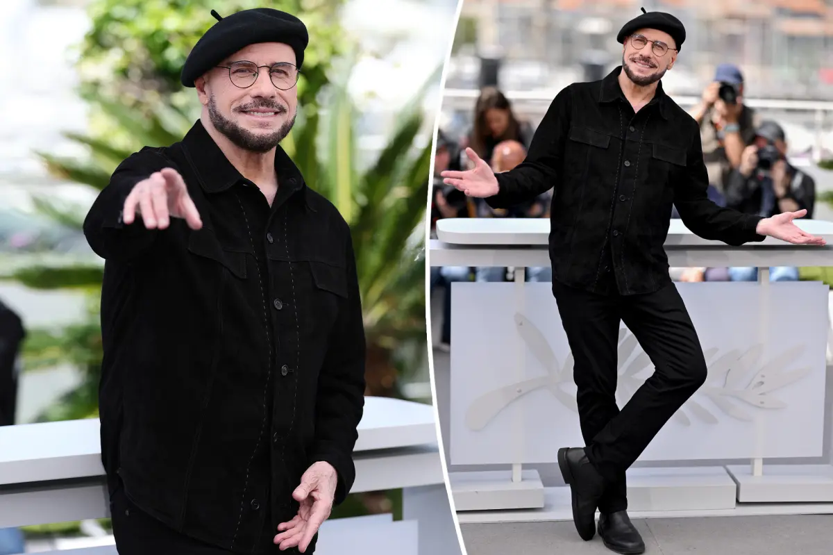John Travolta models another beret at Cannes after being trolled for new look